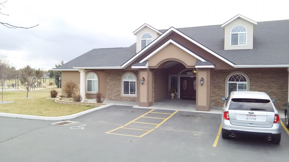A view of a commercial building with brick architecture and a parking lot.