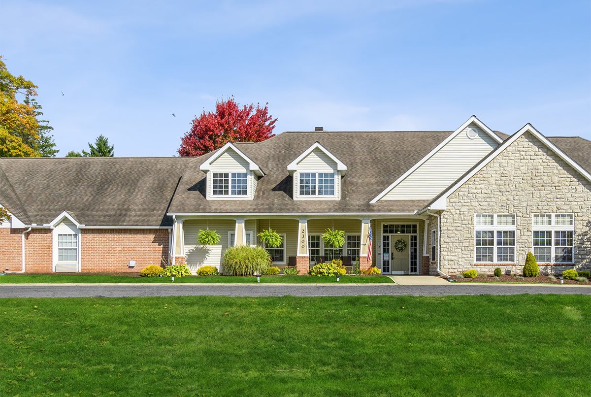 A suburban house with a well-maintained lawn and garden.