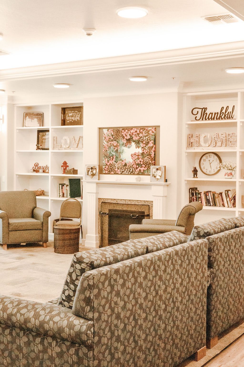 A cozy living room with comfortable seating, a fireplace, and elegant decor.