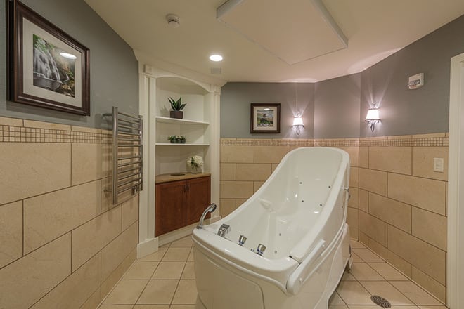 A luxurious spa bathroom featuring a sleek bathtub and elegant interior design.