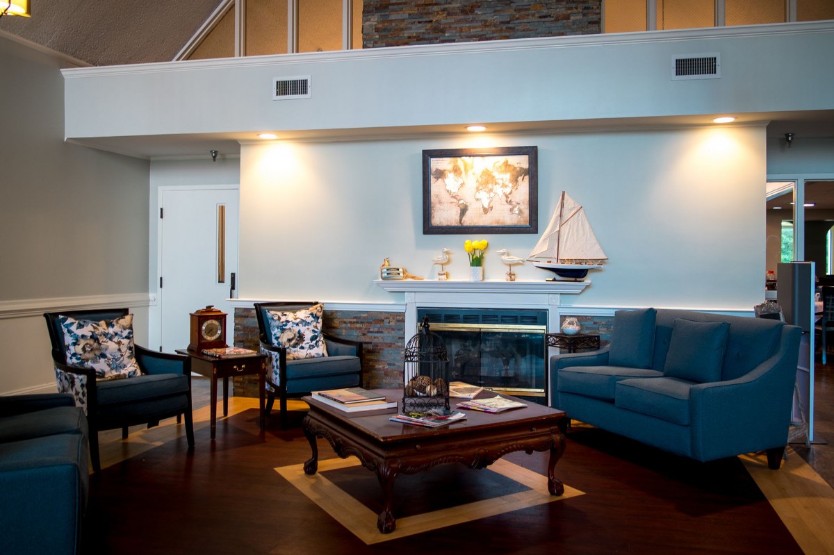 A cozy living room featuring elegant furniture and a beautifully decorated fireplace.