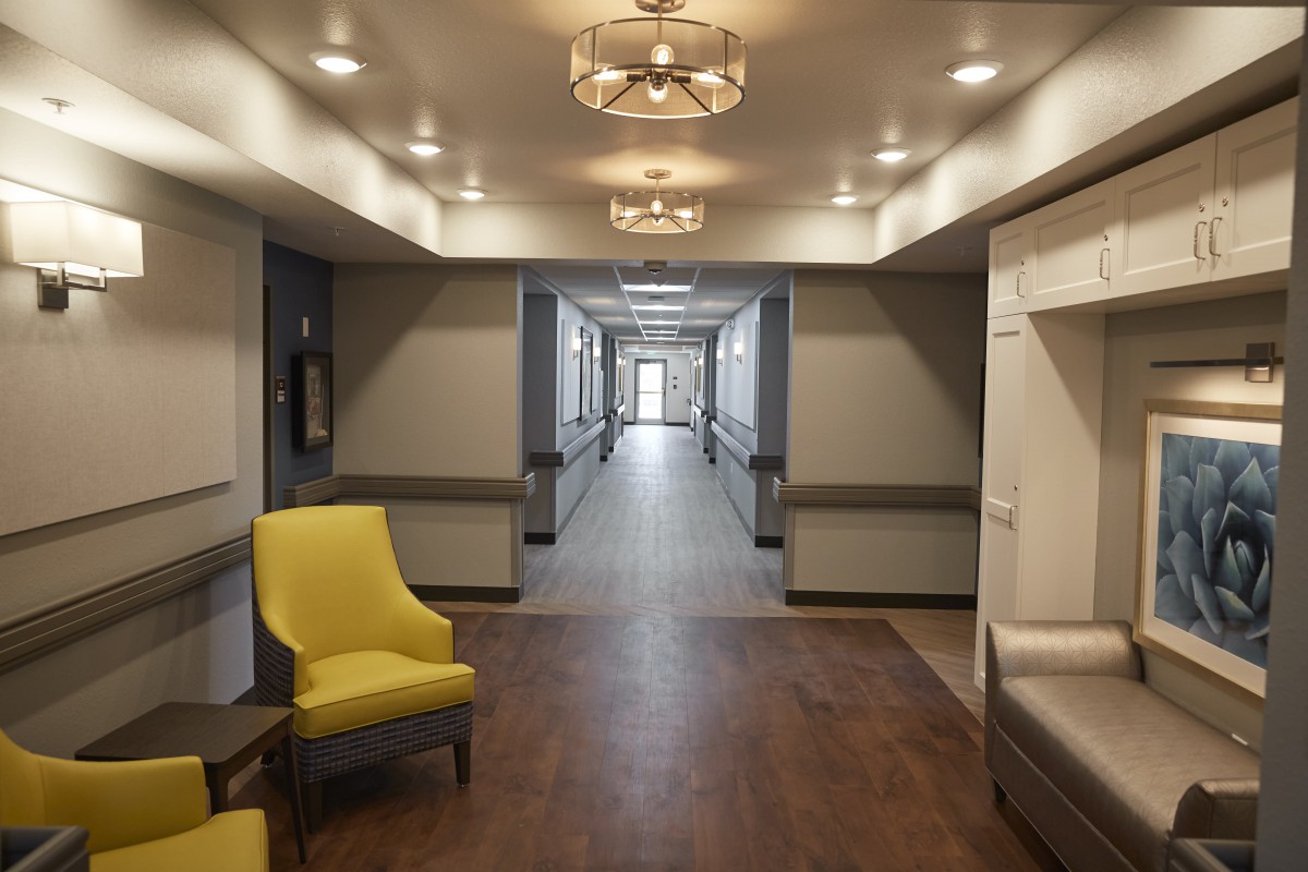 A modern hallway with stylish lighting and comfortable seating.