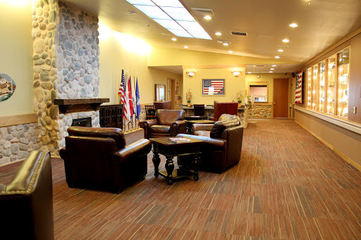 A welcoming lobby space featuring comfortable seating and decorative flags.