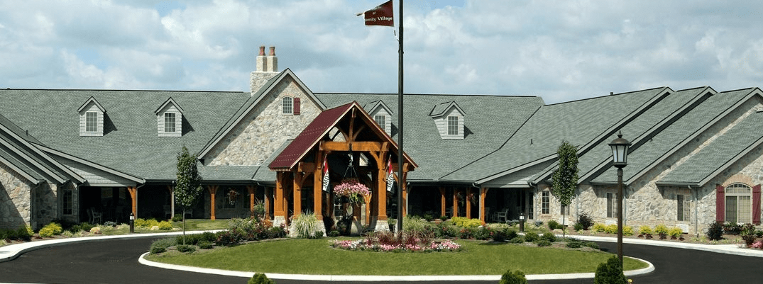 A picturesque building with a flagpole and well-maintained landscaping.