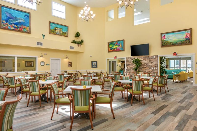 A spacious dining area with elegant furnishings and artwork adorning the walls.