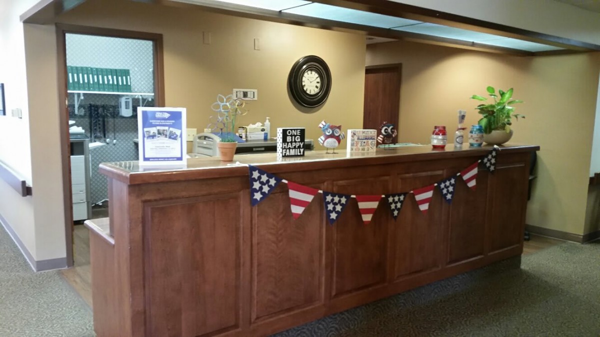 A reception area decorated with a patriotic flag banner and various informational displays on the counter.