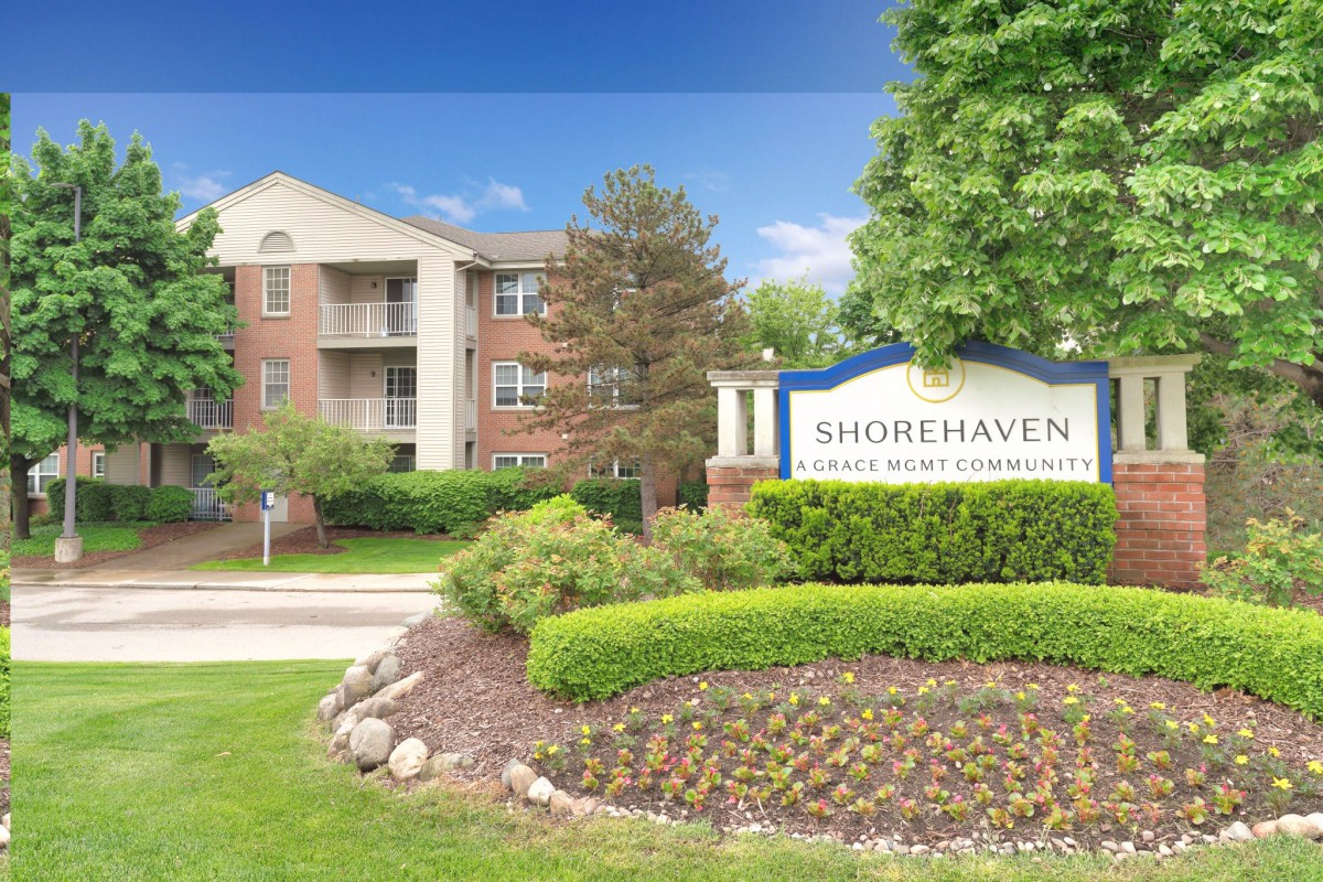 An apartment complex with well-maintained landscaping and a sign for Shorehaven.