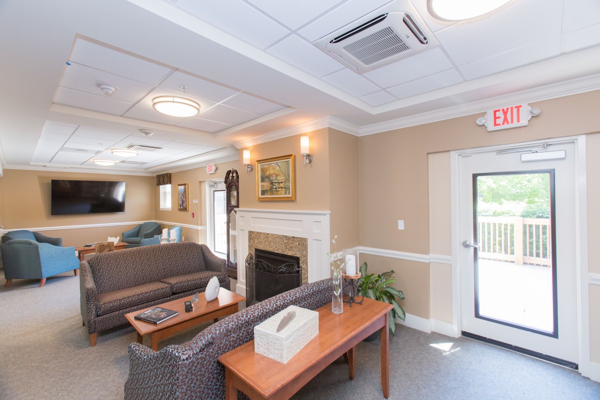 A cozy living room with a fireplace and comfortable seating.