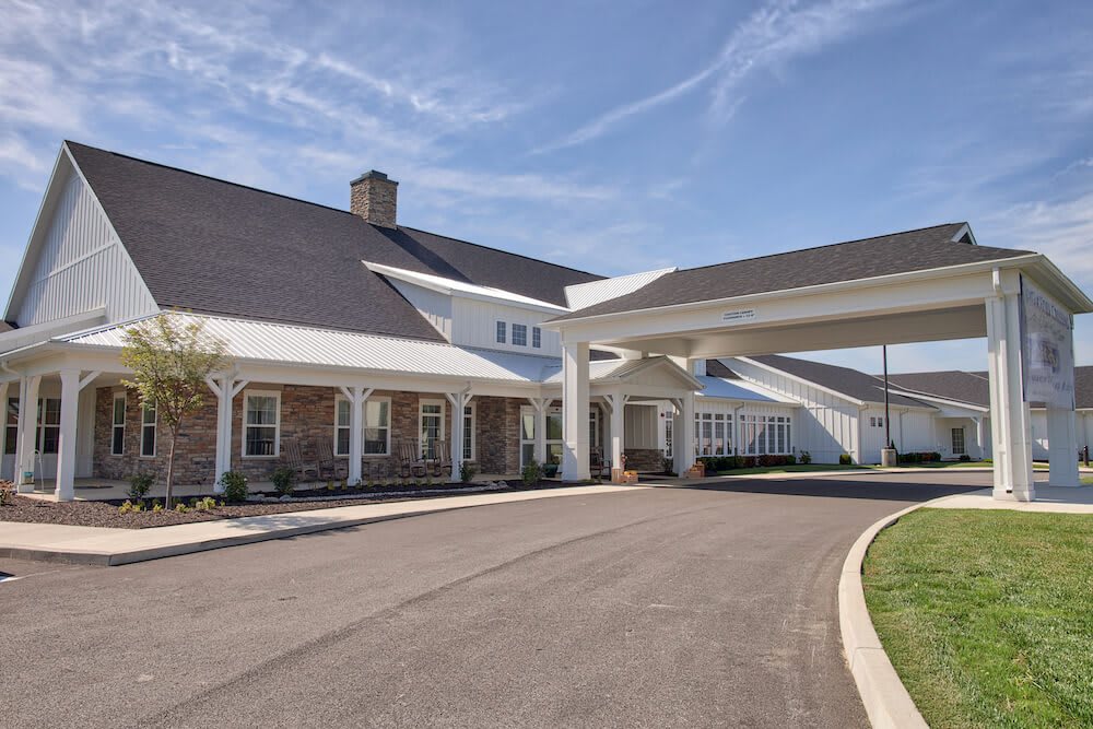 A large building with a covered entrance and driveway.