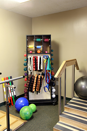A well-organized setup of exercise and rehabilitation equipment in a therapy room.