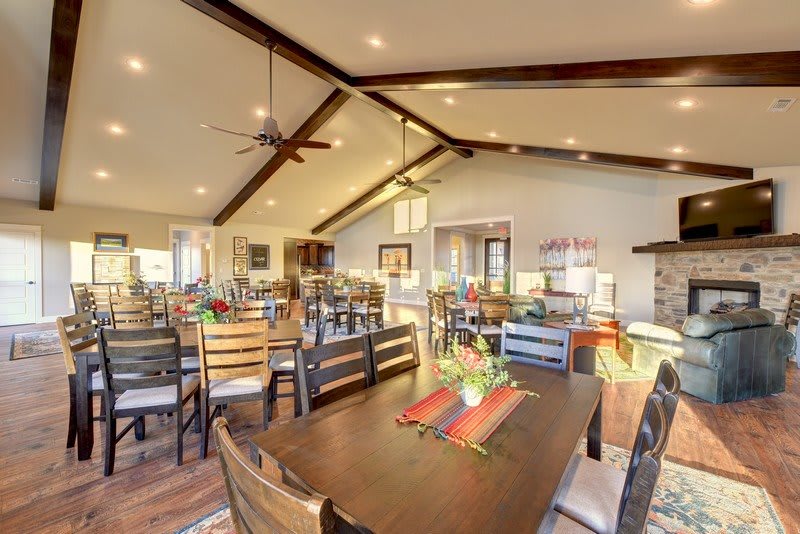 A spacious, well-lit dining area with wooden furniture and contemporary decor.
