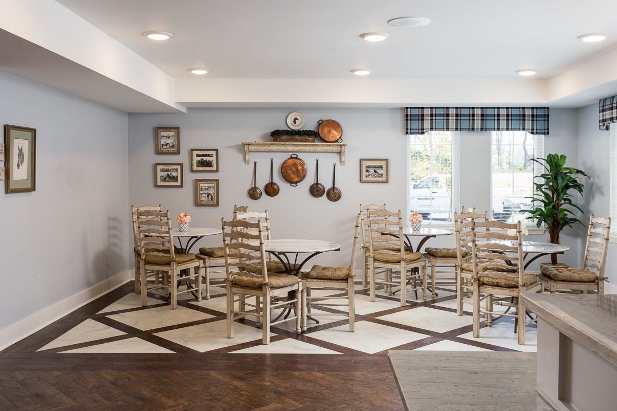 A cozy cafe interior with rustic decor and neatly arranged tables and chairs.