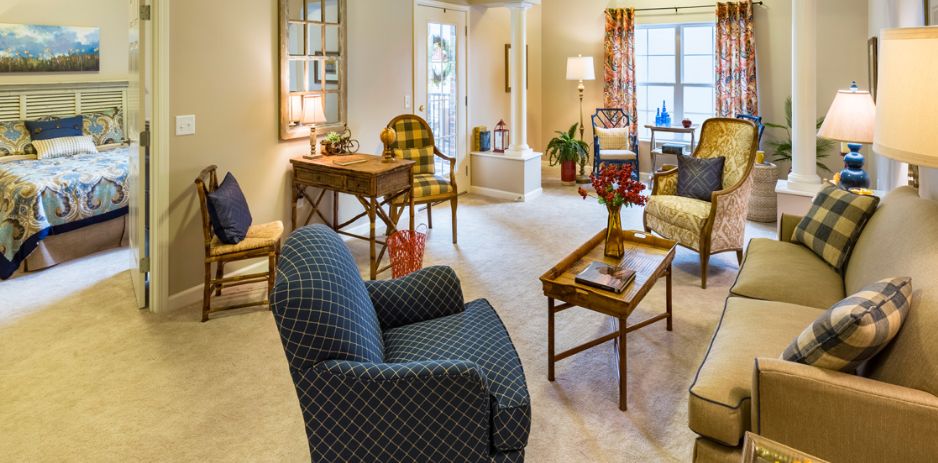 A cozy and traditionally styled living room with comfortable armchairs and a wooden coffee table, creating an inviting atmosphere.