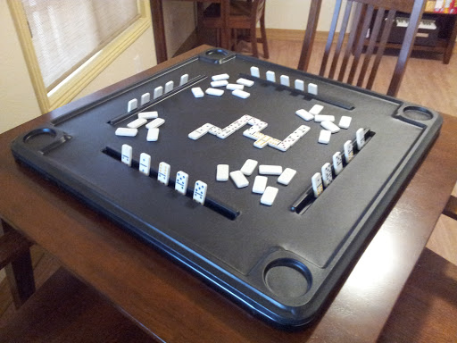 A game of dominoes set up on a table, ready for players to enjoy.