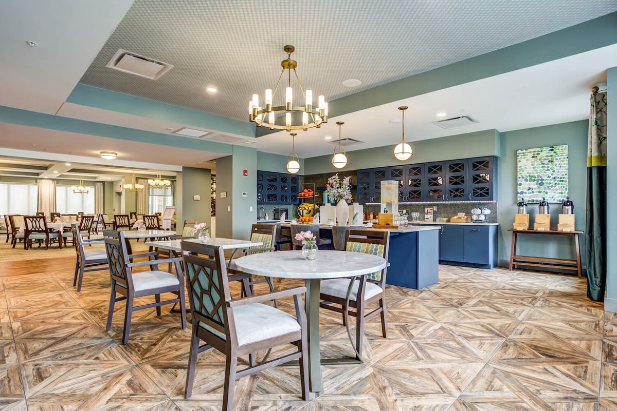 A beautifully designed dining area featuring elegant furniture and a chandelier.