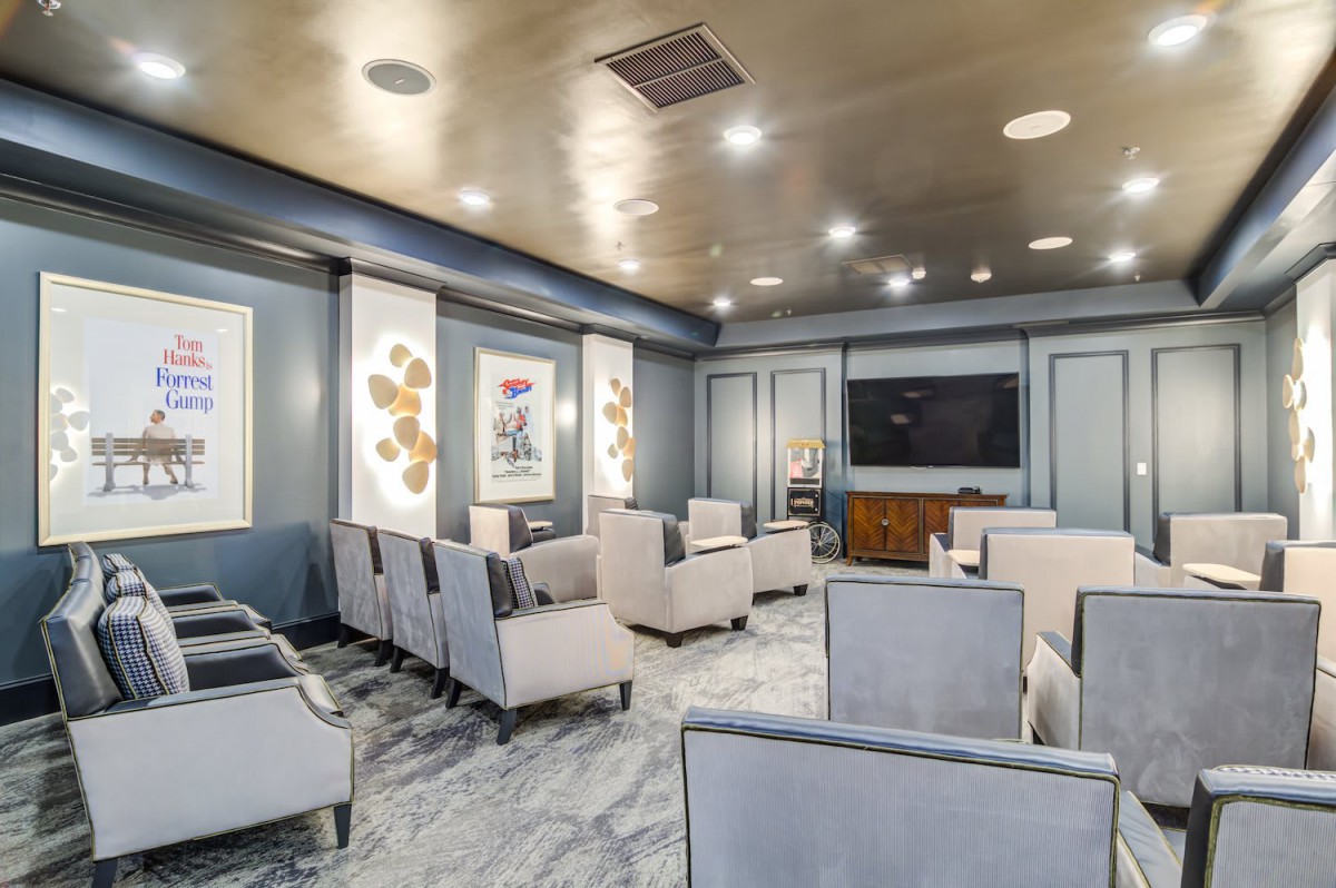 A modern lounge area with comfortable seating, a large television, and stylish decor.