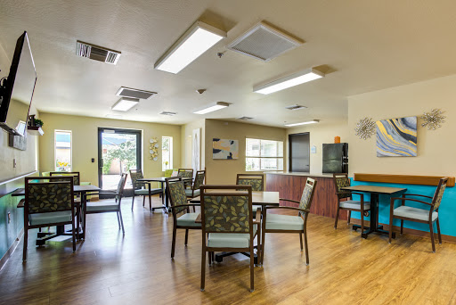 A spacious and well-lit dining area with tables and chairs arranged for communal meals.