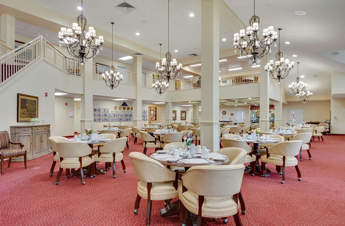 An elegant restaurant interior with chandeliers and well-arranged dining tables.