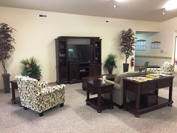 A cozy living room with comfortable seating and a television unit.