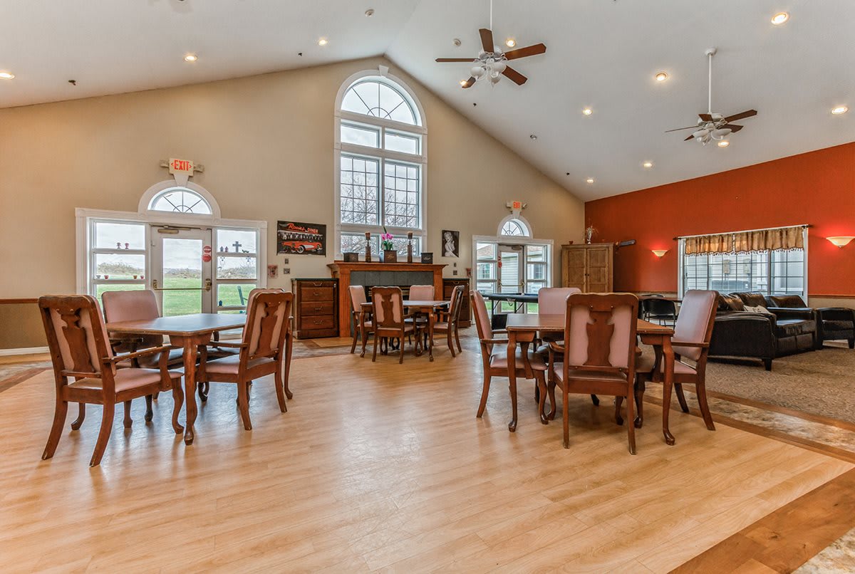 A spacious dining area with traditional decor and large windows.