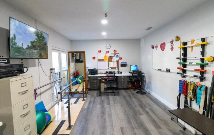 A well-organized office space with a desk, computer, and whiteboard.
