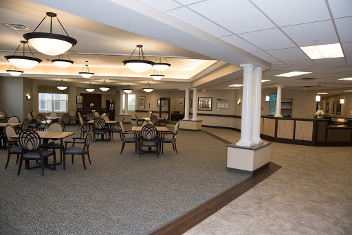A spacious and elegantly designed lobby and dining area with comfortable seating arrangements.