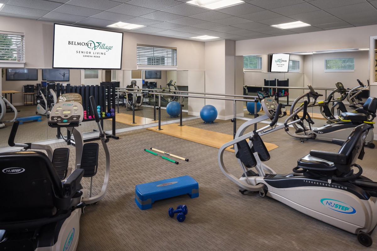 A modern gym with various exercise equipment and workout space.