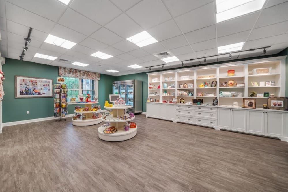 A well-organized retail store interior with products displayed on round tables and shelves.