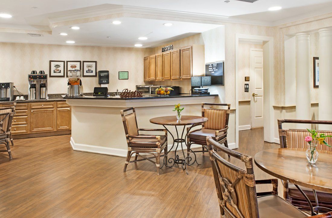 A cozy cafe-style kitchen with wooden flooring and seating.