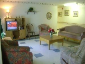 Cozy living room with sofas and a TV setup.