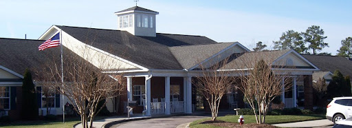 A welcoming residential building with a classic design and a charming front porch.