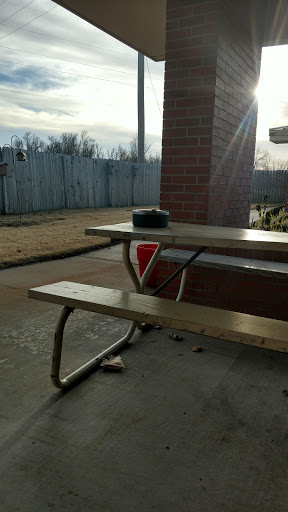A solitary picnic table basking in the warm sunlight on a quiet day.
