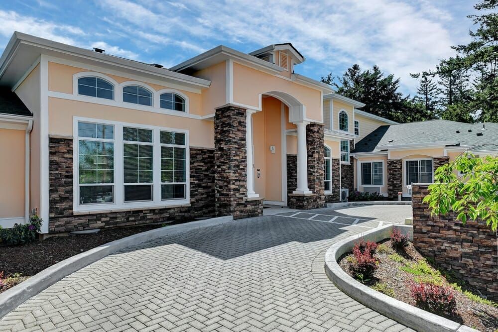 A luxurious modern house with a well-maintained driveway and elegant architecture.