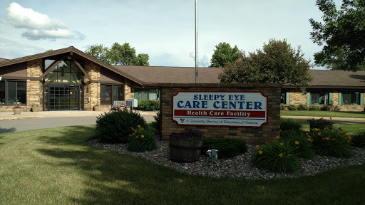 The exterior of a care center, featuring a welcoming sign and landscaped surroundings.