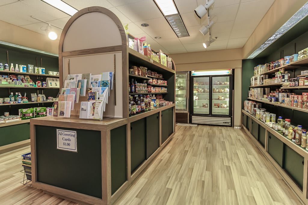 A well-organized store interior with shelves stocked with various products and a wooden floor.