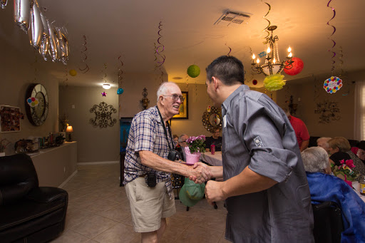 A warm moment shared between two individuals during a festive indoor gathering.