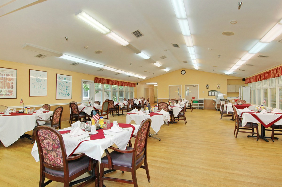 A spacious dining area with neatly arranged tables and chairs, ready for guests.