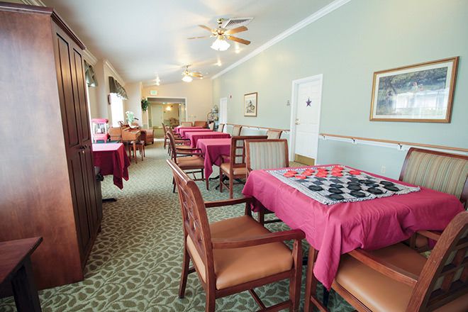 A cozy dining area with tables and chairs, featuring checkered tablecloths.