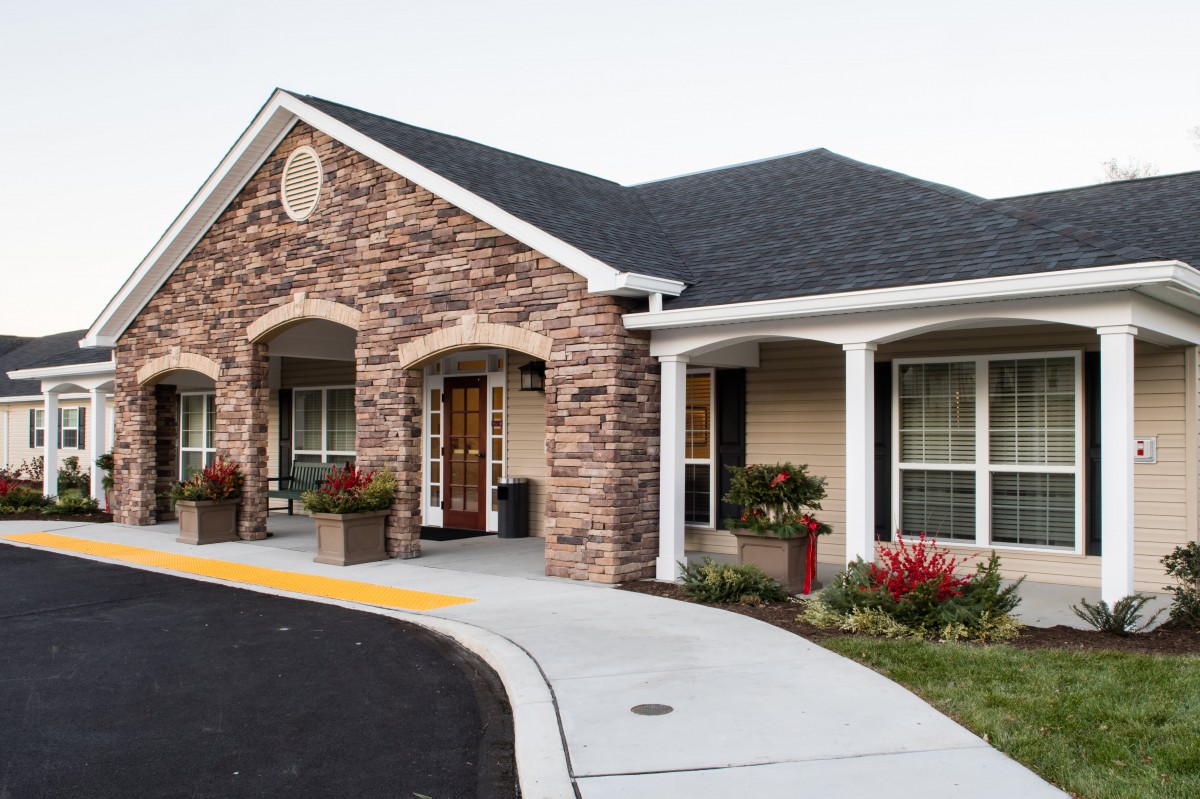A modern house with a brick facade and a welcoming front porch.
