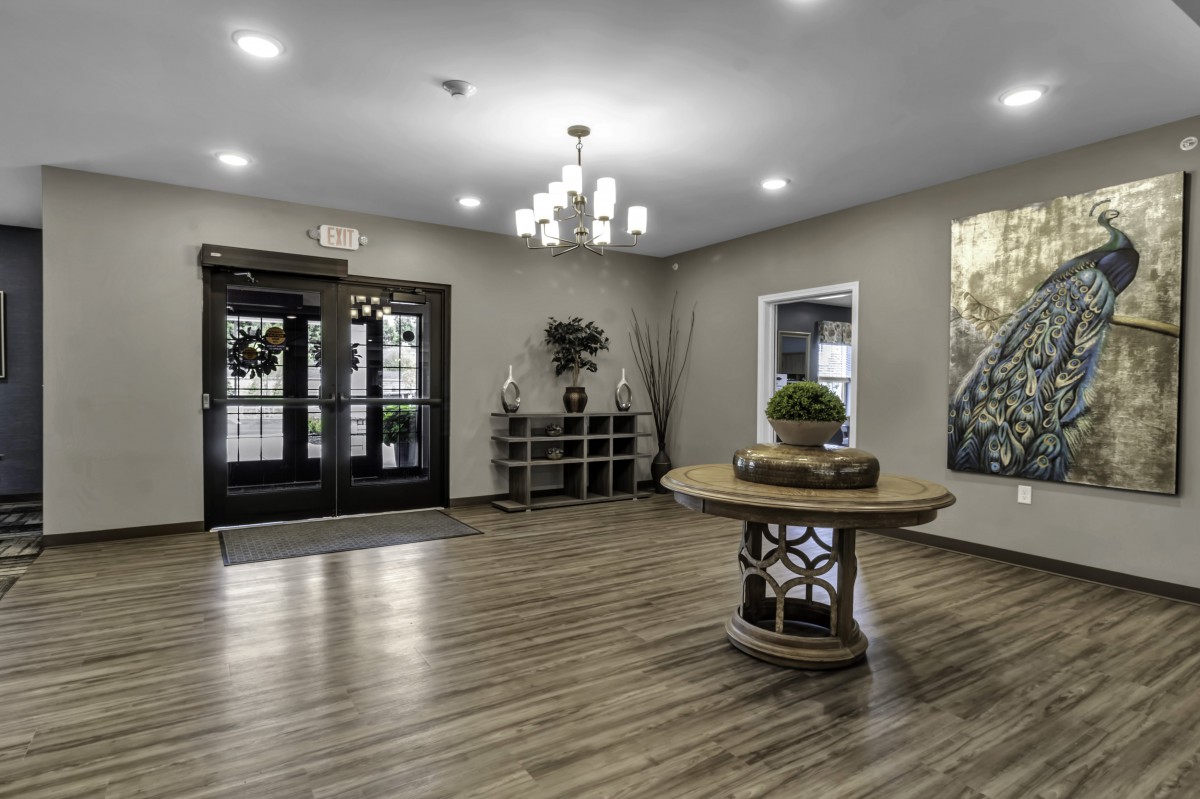 A modern lobby entrance with stylish decor and a central round table.