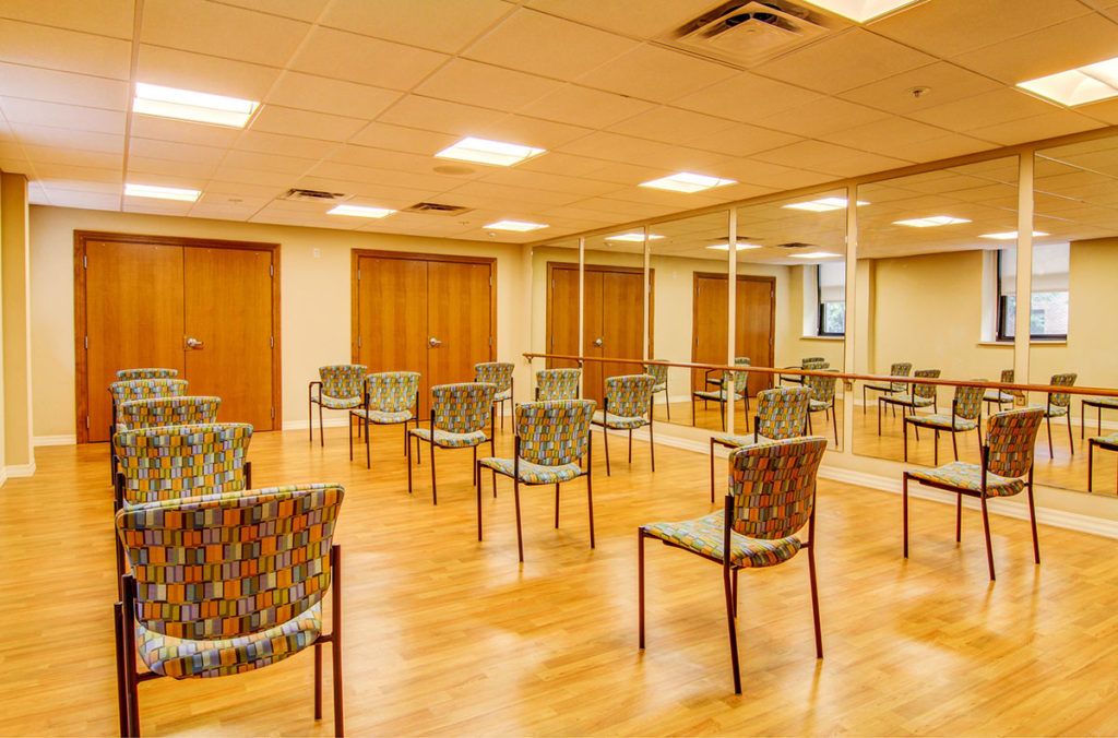 An empty room with chairs arranged for a meeting or workshop.