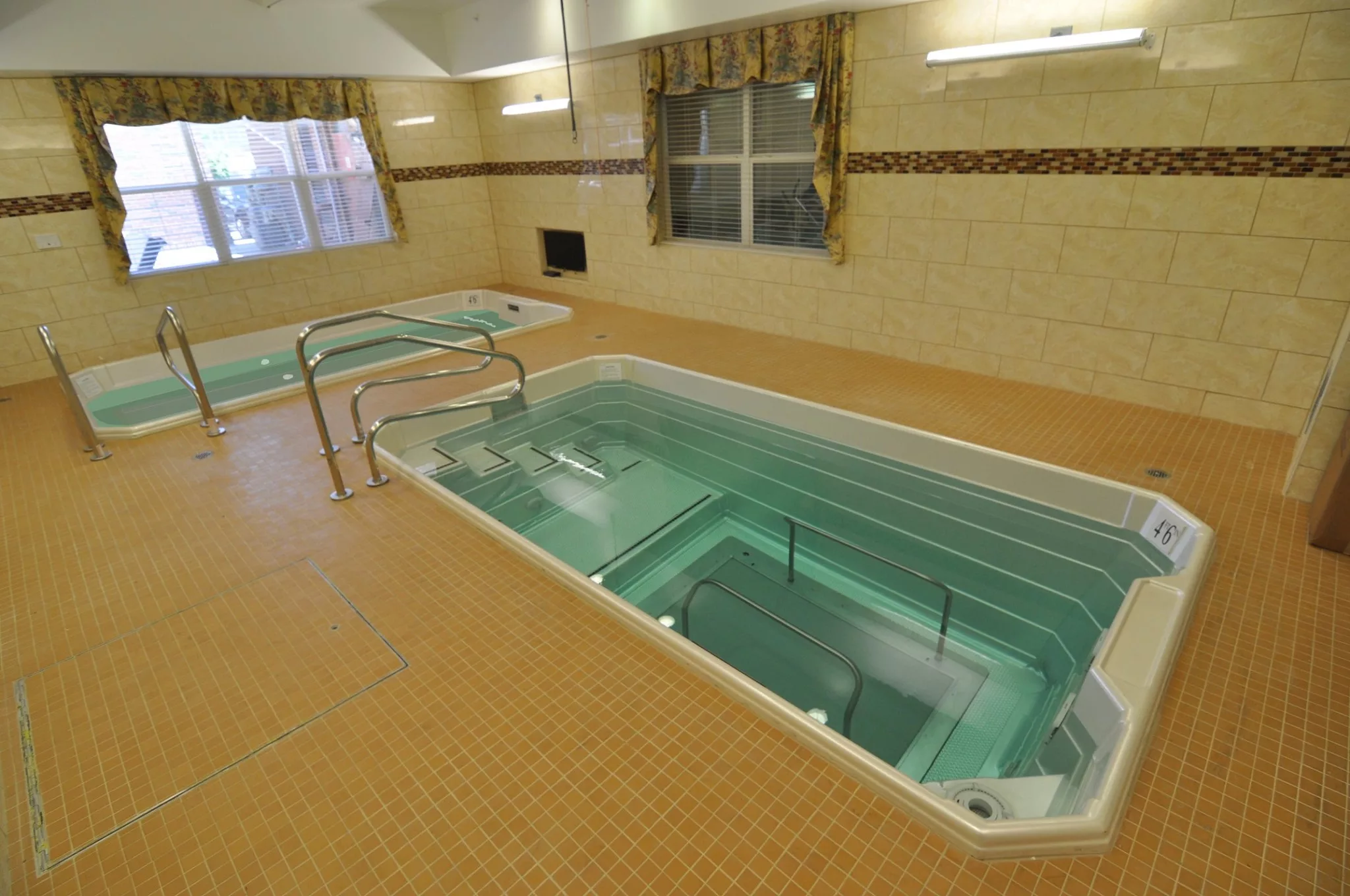 An indoor therapy pool designed for hydrotherapy and rehabilitation exercises.