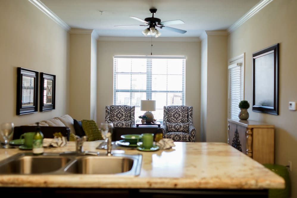 A modern open-concept kitchen and living room with a bright window view.