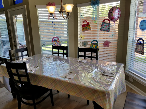 A beautifully decorated dining table ready for a celebration, complete with colorful decorations and a cozy ambiance.