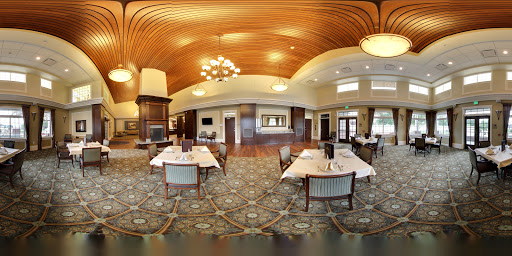 A spacious and elegantly designed dining area featuring wooden ceilings and stylish furnishings.