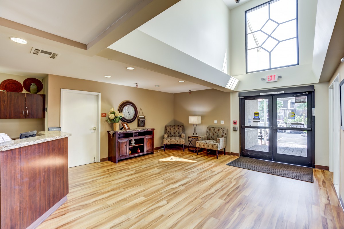 A modern lobby area with a reception desk and comfortable seating.