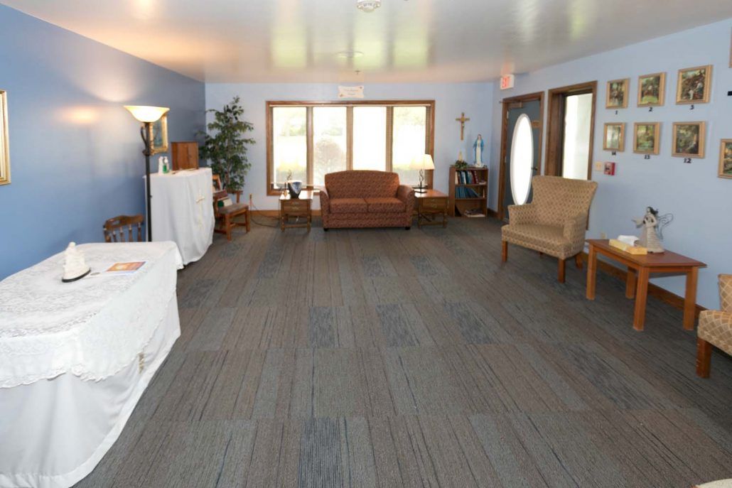 A cozy living room with comfortable seating and natural light from large windows.