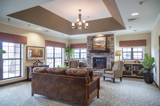 A cozy and modern living room featuring comfortable seating, a fireplace, and ample natural light.