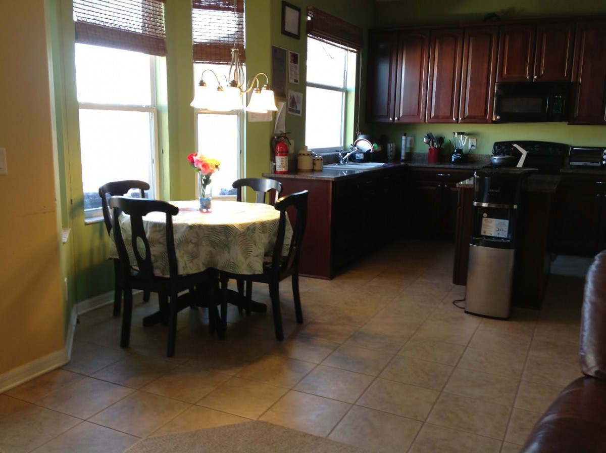 A cozy kitchen and dining area with natural light streaming through the windows.