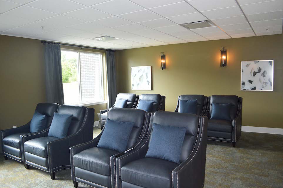 A comfortable lounge area with rows of plush, reclining chairs in a well-lit room.